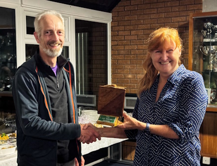 Photo of Charles Mayes receiving 
the Joe Wright Trophy from Caroline Mackenzie