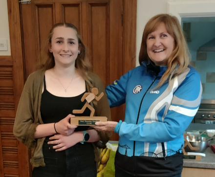 Photo of Becca Mayes receiving 
the Paul Thornton Trophy from Caroline Mackenzie
